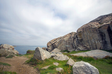 Dalkey cliffs and rocks seashore in sunny day, rocks on the seashore, Dublin county, Ireland                                                                                                          