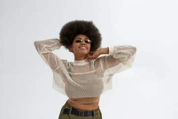 Young pretty culry black woman posing in glasses