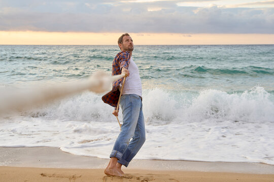 Man pulling rope on shore at beach