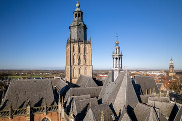Typical steep multiple church roofs of Walburgiskerk and tower in historic medieval city center of...