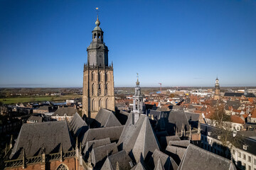 Graphic steep multiple church roofs of Walburgiskerk and tower in historic medieval city center of...
