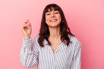 Young caucasian woman isolated on pink background laughing about something, covering mouth with hands.