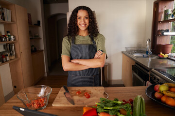 Portrait of multi-cultural female smiling in her modern kitchen. Happy and confident at home