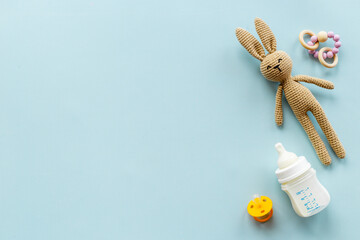 Child toy knitted rabbit with milk bottle, overhead view