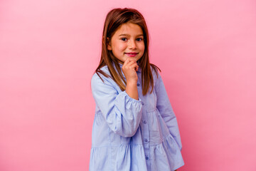 Little caucasian girl isolated on pink background  smiling happy and confident, touching chin with...