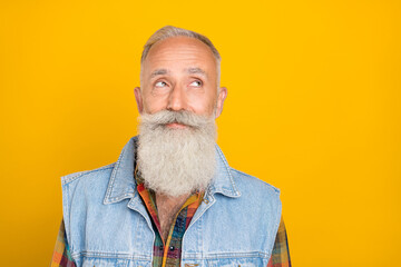 Photo of retired man wondered look empty space imagination outfit isolated over yellow color background
