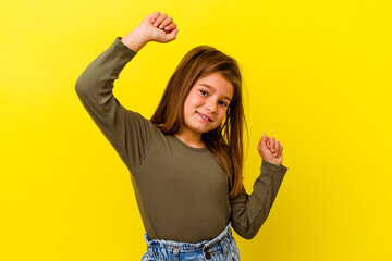 Little caucasian girl isolated on yellow background celebrating a special day, jumps and raise arms...