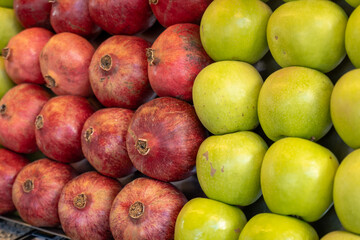 Pomegranate and apples on display at market. Fresh organic fruits for smoothies, fruit salad, juice