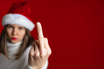 Fototapeta na wymiar Fuck haters show sign. Portrait crazy girl on x-mas, isolated red color background