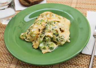 wholesome breakfast. omelet with broccoli on green plate