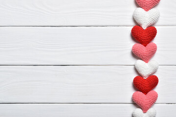Valentine's Day banner with knitted hearts. Flat lay, top view.