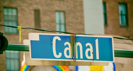 Canal Street sign with beads in New Orleans after Mardi Gras Parade.