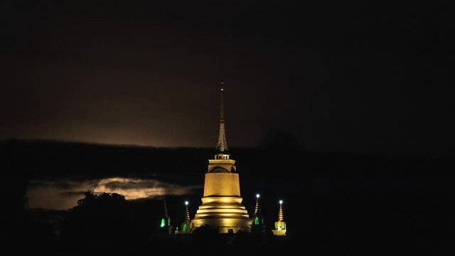 Pagoda Khao Hua Jook, the fullmoon move over Golden pagoda with warm cloud , twilight sky to moon night sky at Chaweng , Koh samui , suratthani , thailand	
