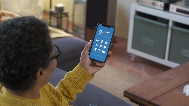 Woman using smart home app on her home