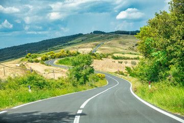 Naklejka premium Beautiful road across Tuscan countryside, Italy in spring season.