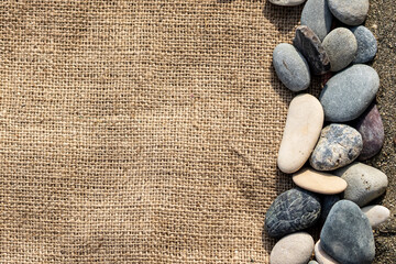 Burlap fabric and beach stones 
