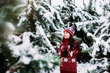 Girl in the winter snowy forest