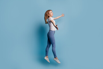 Profile photo of inspired lady jump stretch hands invite welcome hug wear casual clothes on blue color background