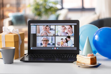 technology and online communication concept - laptop computer with happy people on screen having...
