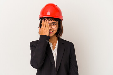 Young architect woman with red helmet isolated on white background having fun covering half of face with palm.