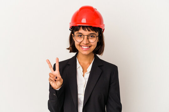 Young architect woman with red helmet isolated on white background showing victory sign and smiling broadly.