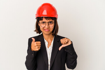 Young architect woman with red helmet isolated on white background showing thumbs up and thumbs down, difficult choose concept