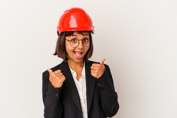 Young architect woman with red helmet isolated on white background raising both thumbs up, smiling and confident.