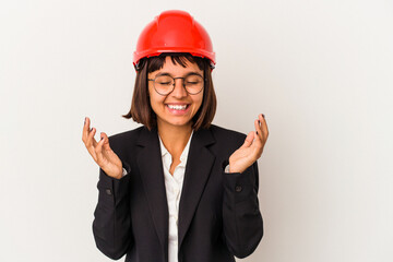 Young architect woman with red helmet isolated on white background joyful laughing a lot. Happiness concept.