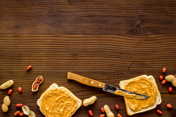 Spread peanut butter sandwiches with nuts. Top view