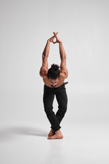 Handsome black topless guy posing in studio.