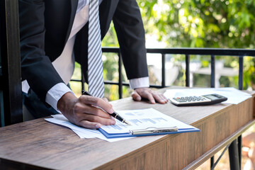 Young businessman financial market analyst sits at their desks and calculate financial graphs showing the results of their investments planning the process of successful business growth