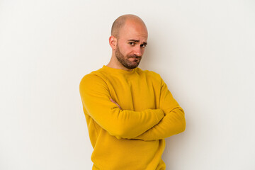 Fototapeta premium Young bald man isolated on white background suspicious, uncertain, examining you.