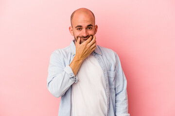 Young caucasian bald man isolated on pink background  doubting between two options.