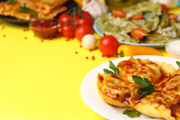 Delicious food concept with ravioli on yellow background