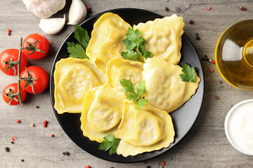 Delicious food concept with ravioli on textured background