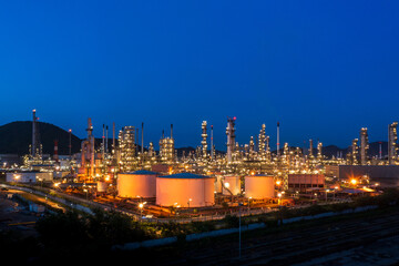 Fototapeta na wymiar Aerial view. Oil refinery factory and oil storage tank at twilight and night. Petrochemical Industrial.