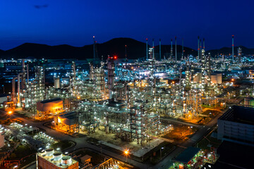 Aerial view. Oil refinery factory and oil storage tank at twilight and night. Petrochemical Industrial.