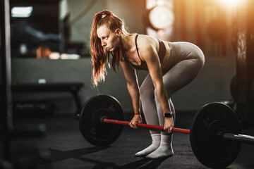 Fototapeta na wymiar Fit Woman Weightlifting At The Gym