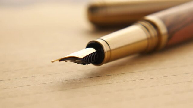 envelope , empty paper and fountain pen on table 