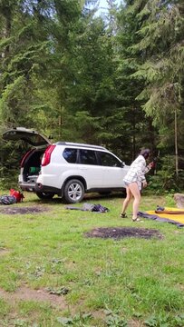 time lapse woman pitch a tent near suv car at the forest
