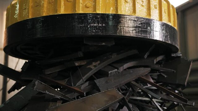 A huge electromagnet is pulling scrap metal