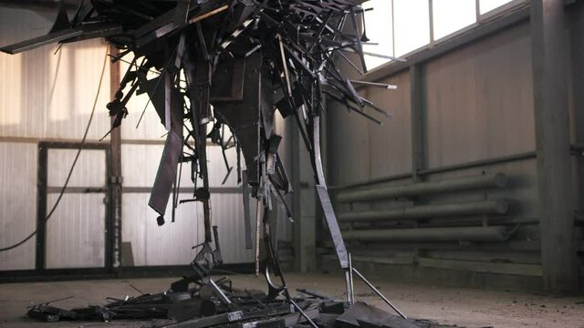 A huge electromagnet is lifting scrap metal