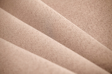 Background, texture. Template. Satin cloth for wedding and evening dresses. A nude shade.