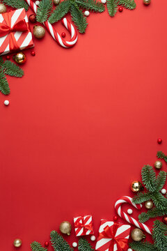 Christmas frame for text with fir decorations and gifts on red background