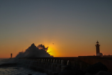 sunset waves lighthouse breakwater