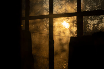 The sun shines through the window in the morning. Warm atmosphere in the air.