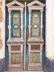 Ancient old door of a house on the street of Europe. Vertical.