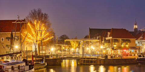 Fototapeta na wymiar View with christmas decoration of the harbor in the Dutch ancient city center of Hoorn, The Netherlands