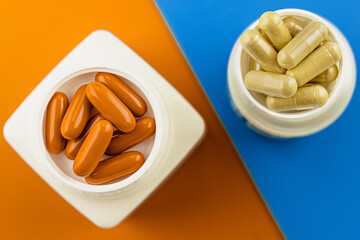 pills supplement capsules and softgels on a cozy color combination background. immune support...