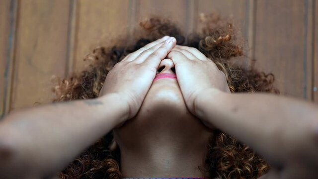 Woman filled with regret covering face with hands